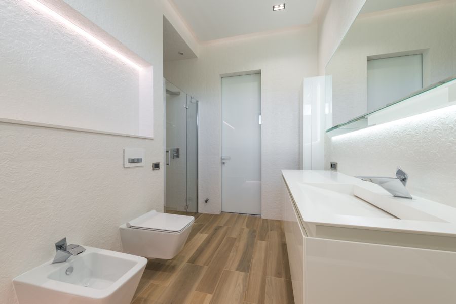 Wall-hung white toilet and bidet in a modern bathroom