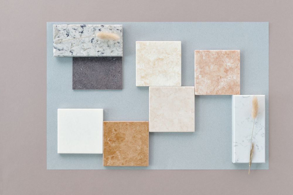 Marble and stone tile samples laid out on a table